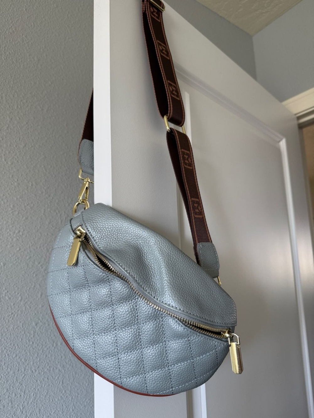 Cute crossbody leather sling bag in light blue.